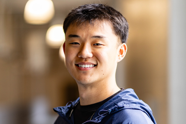 A young East Asian man smiles