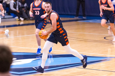 A white brunette young man plays basketball