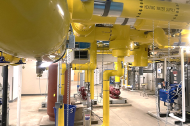 A room filled with yellow pipes of different sizes