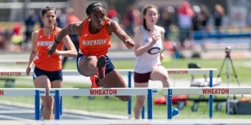 Wheaton College Womens Track and Field Champion Favor Ezewuzie jumping a hurdle