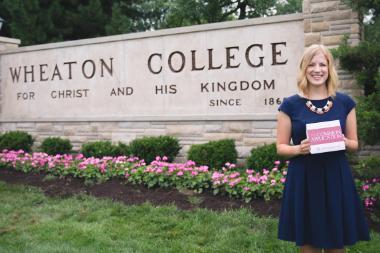 Admissions counselor in front of Wheaton sign holding common application