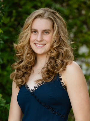 A white blonde young woman smiles
