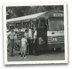 Coach Harvey Chrouser welcomes campers on the bus taking them to Boys' Camp at HoneyRock. 