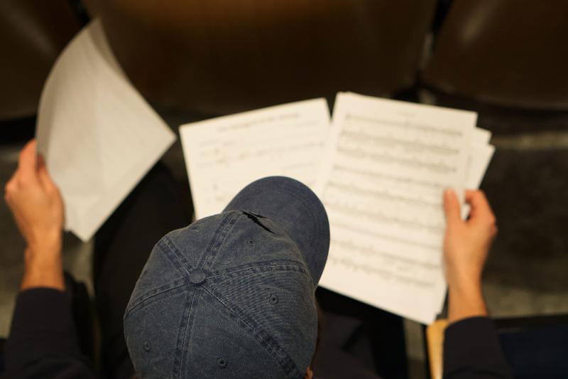 Student looking at music sheets