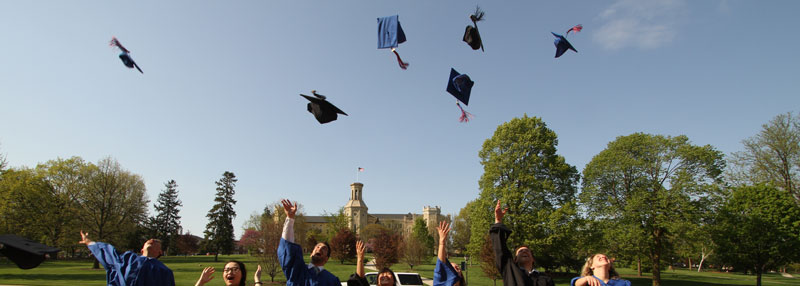 Commencement Caps Thrown by Graduates in Front of Blanchard